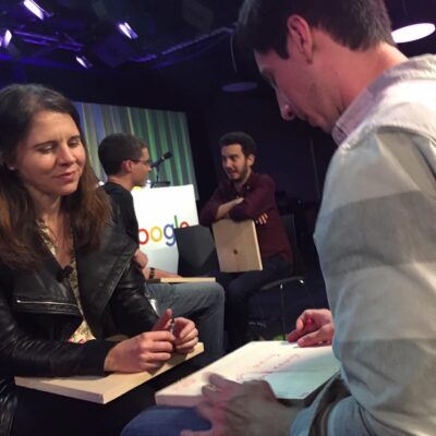 Participants engage in a reflective discussion during a board-breaking team building session, preparing to break through personal barriers. thumbnail