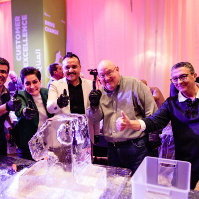 A group of participants gives a thumbs up next to their ice sculpture, celebrating teamwork and creativity during an exciting Team building Ice Sculpting challenge. thumbnail