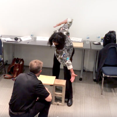 A participant prepares to break a board during a transformational team building activity, symbolizing the act of overcoming personal and professional obstacles. thumbnail