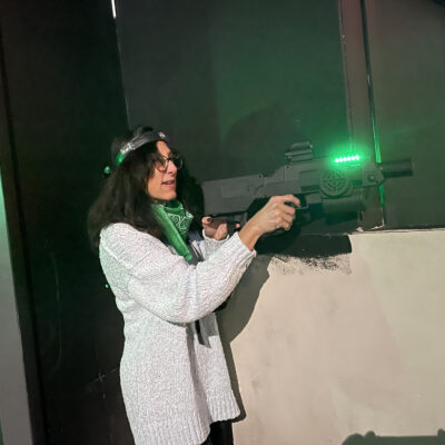 Participant enjoys a laser tag adventure during The Mystery Bus team building event, featuring surprise destinations and fun activities. thumbnail