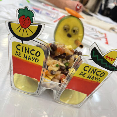 A Cinco de Mayo-themed dish with a creative presentation featuring glasses decorated with fruit and a playful garnish, showcasing the fun and festive atmosphere of the Salsa Showdown team building event. thumbnail