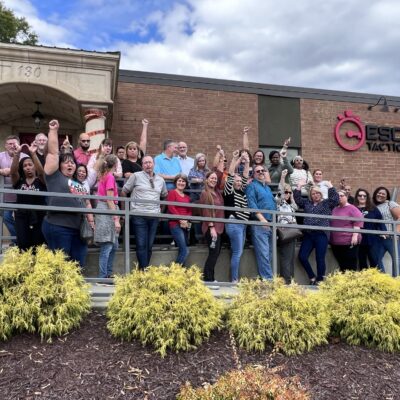 Team celebrating success after completing an escape room challenge during their Mystery Bus team building event, showcasing teamwork and problem-solving skills. thumbnail