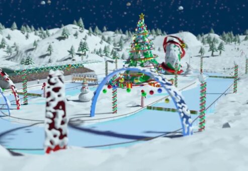 Snowy racetrack decorated with candy canes and Christmas lights, featuring a large Christmas tree, snowmen, and holiday-themed arches from the Reindeer Games team building event.