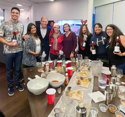 Team celebrating after a successful mixology session, holding their cocktail creations. The event fosters teamwork, creativity, and fun as participants bond over crafting drinks in a lively atmosphere. thumbnail